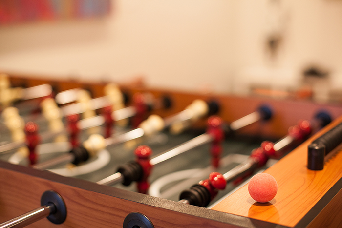 An image of a pool table with a single ball resting on its edge.
